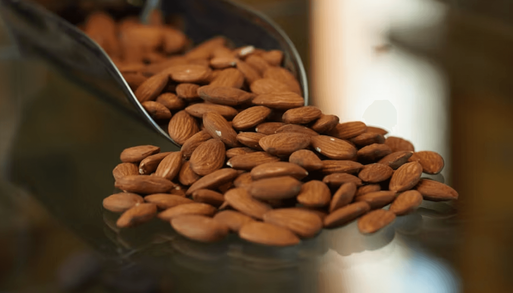 A scoop of almonds being measured.